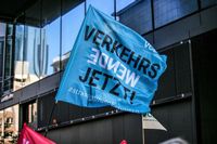 Wehende blaue Fahne auf der steht „Verkehrswende Jetzt!“