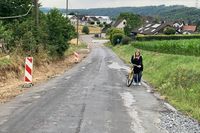 Frau mit Fahrrad bergan